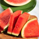 Seedless watermelon slices on wooden background, summer fruit